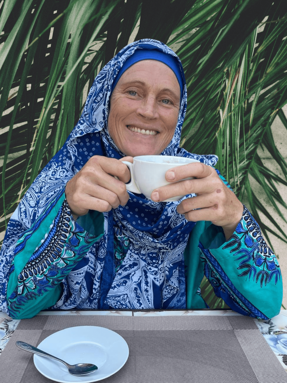 Smiling Muslim trauma-informed coach inviting women to begin their healing journey