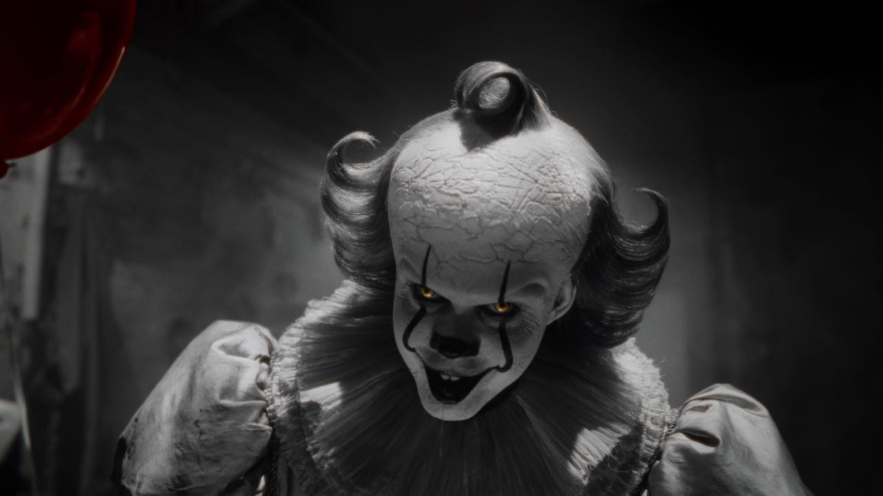 Pennywise in monochrome key art for HBO's It: Welcome to Derry, eyes glowing yellow