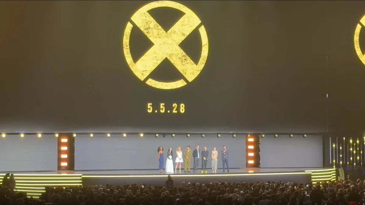 The X-Men movie cast on stage at D23 with the 2028 release date on screen