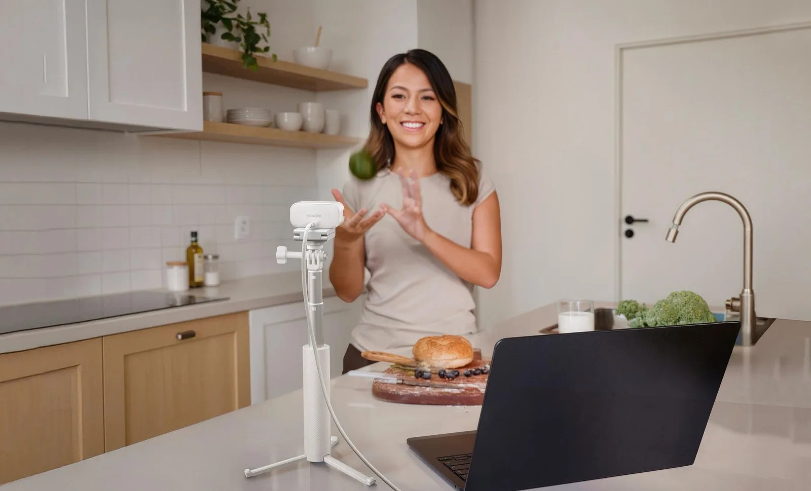 Insta360 Link 2 Pro in Arctic White filming a creator in a bright kitchen workspace