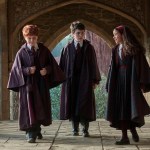 Harry Potter, Ron Weasley and Hermione Granger walk the Hogwarts cloisters in HBO's Harry Potter series