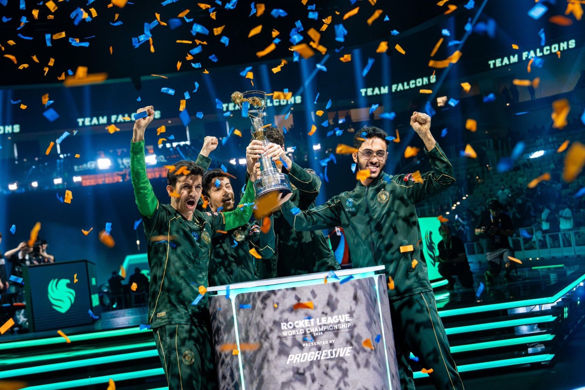 Team Falcons players celebrate with the Rocket League World Championship trophy