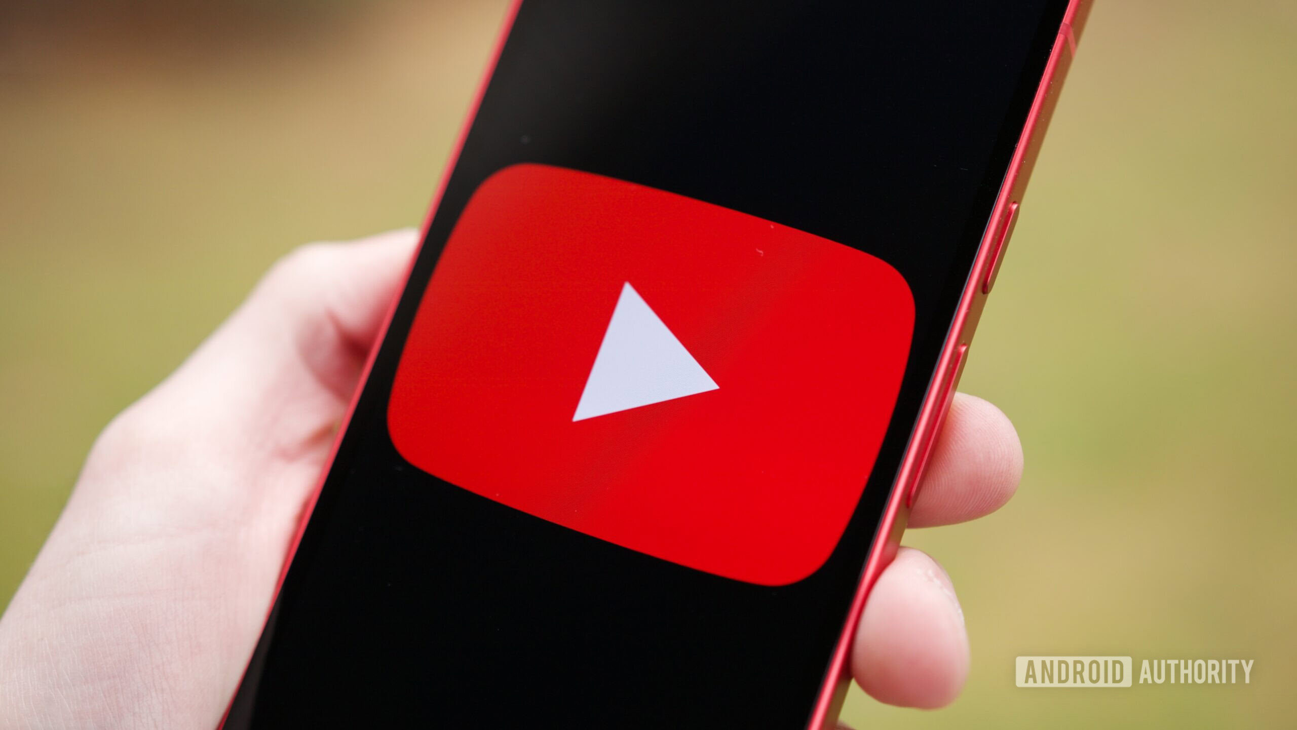 YouTube logo displayed on a phone during homepage loading outage