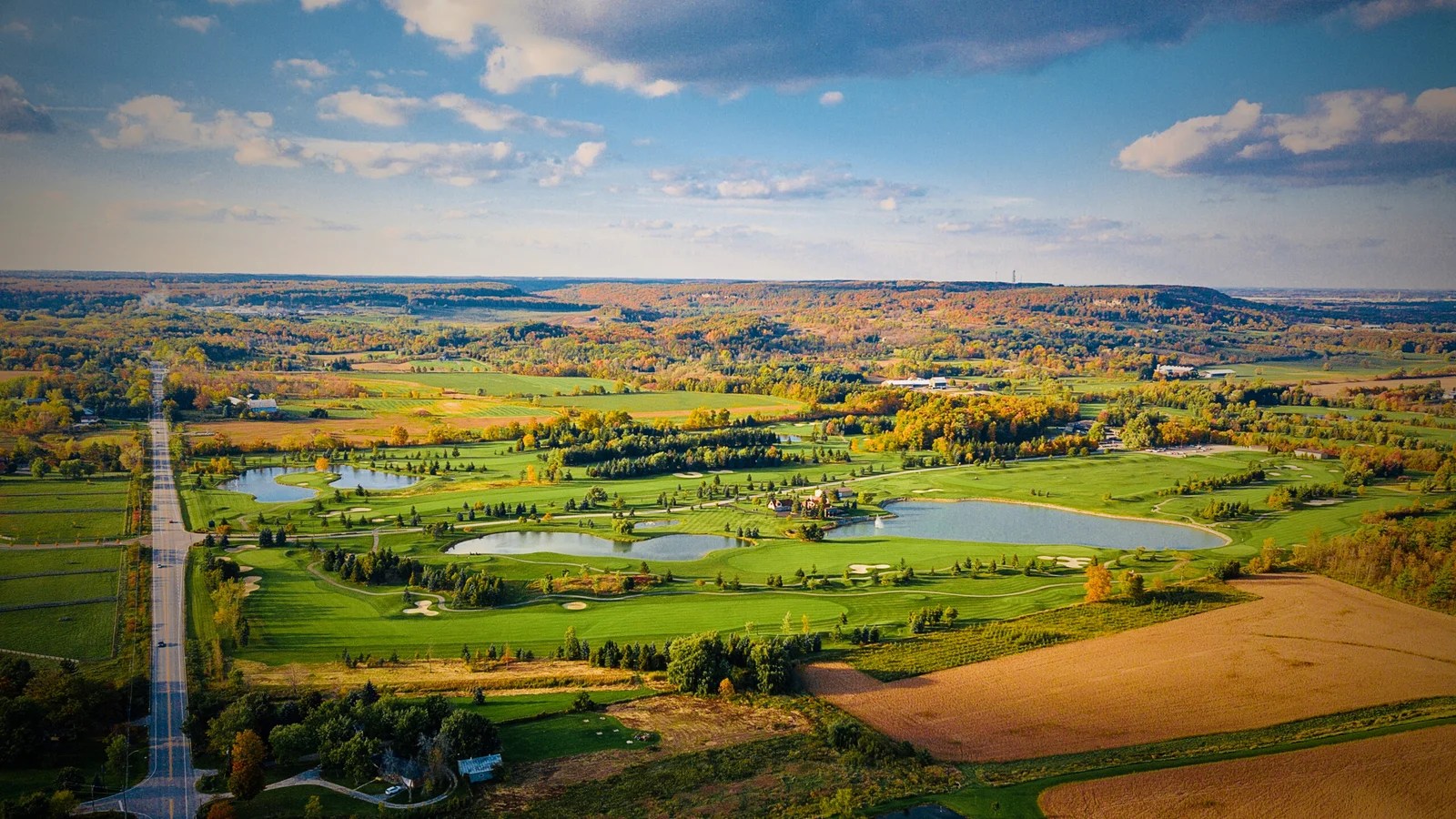 Aerial view of a golf course, ponds and surrounding countryside along Guelph Line in Burlington, Ontario
