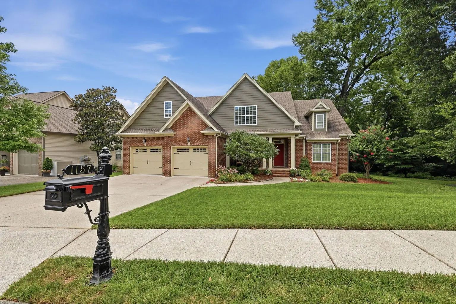 luxury living at 1157 hidden creek drive in chattanooga, tn featuring a private horse creek farm home with pond views, a main-level primary suite, and timeless brick architecture.