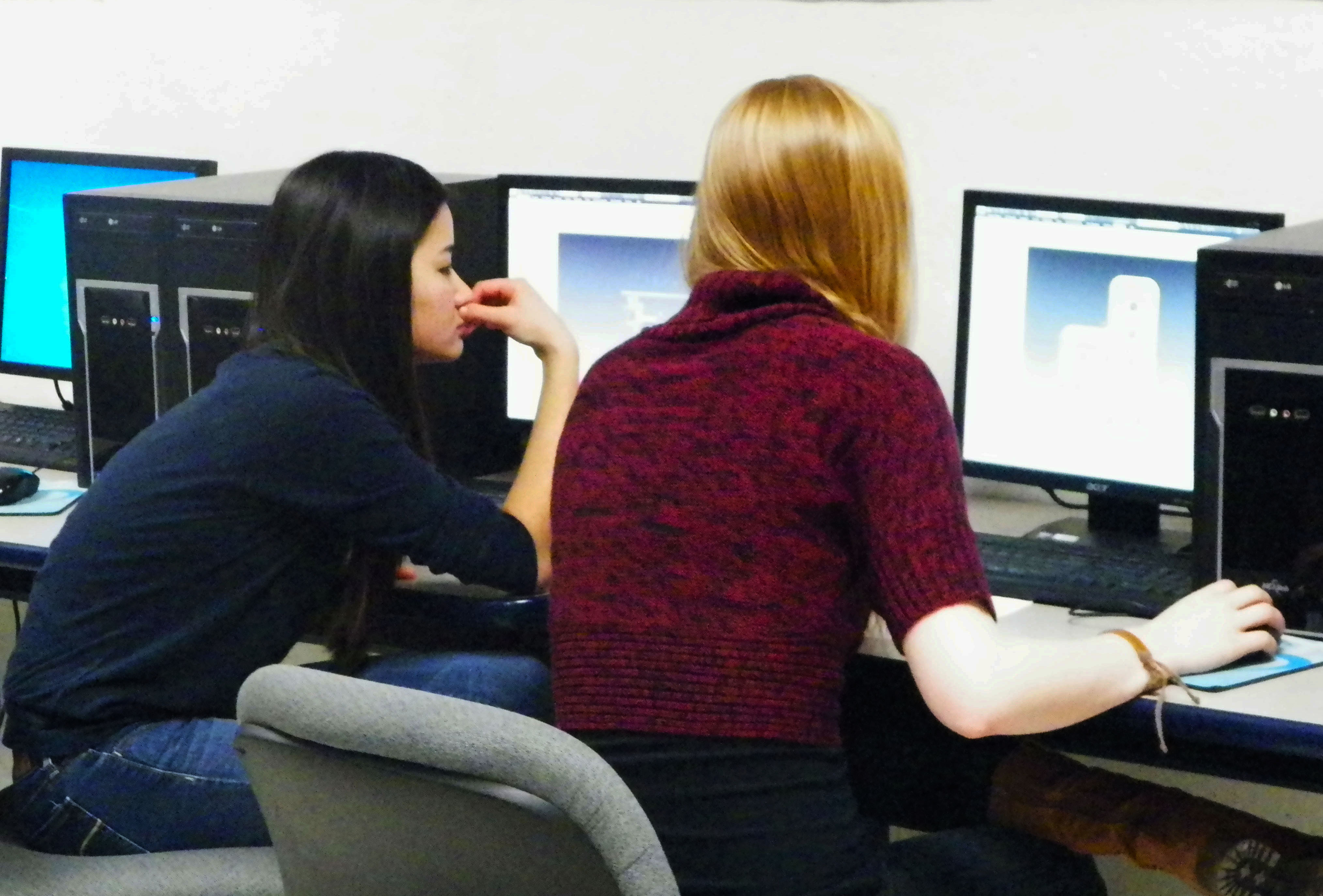Some of our lady team members work on designing robot parts on CAD.