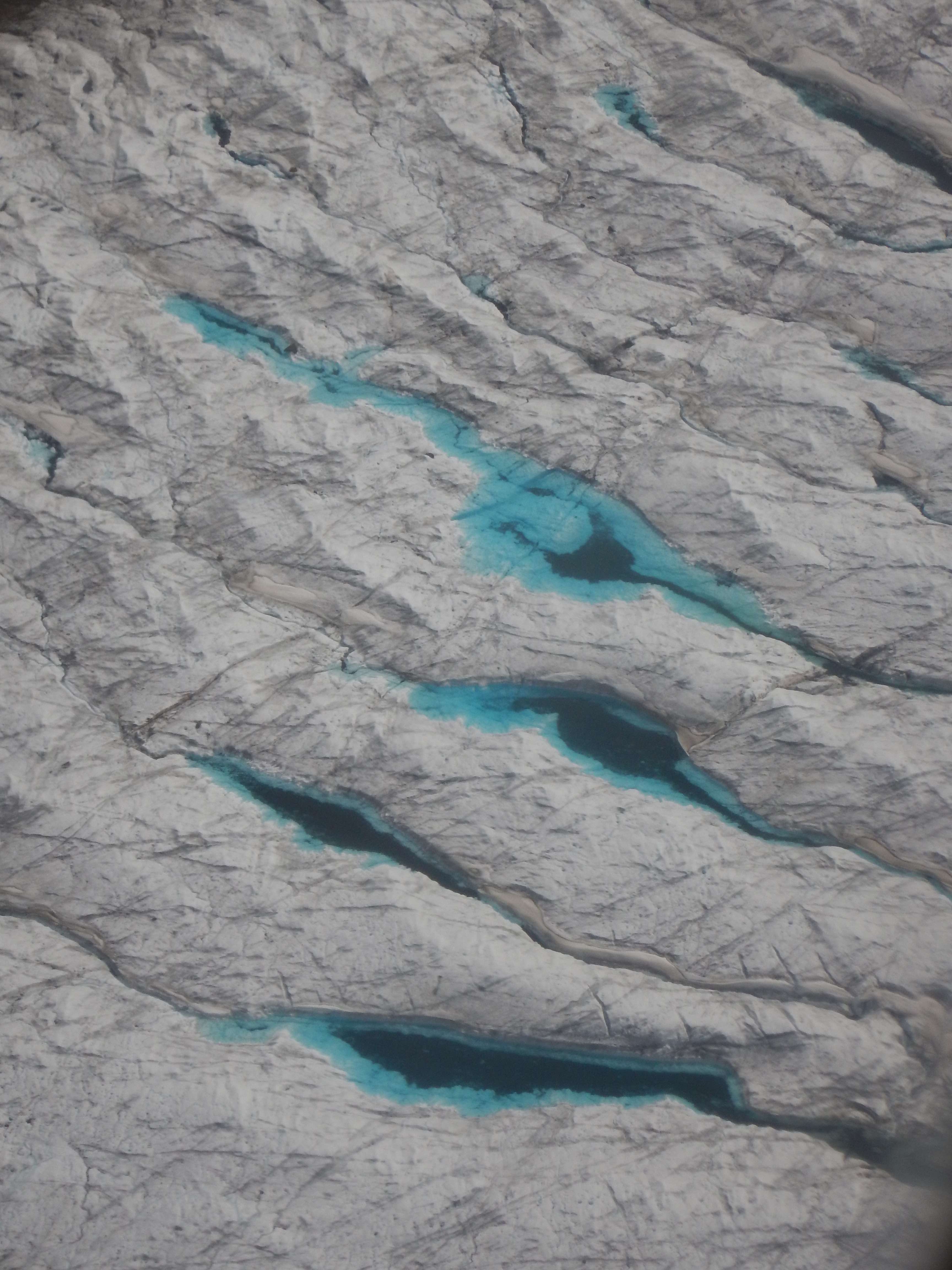 Crevasses filled with blue water.