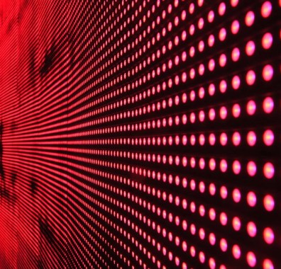 services-img Vibrant abstract pattern of illuminated red LED lights forming a dynamic design.