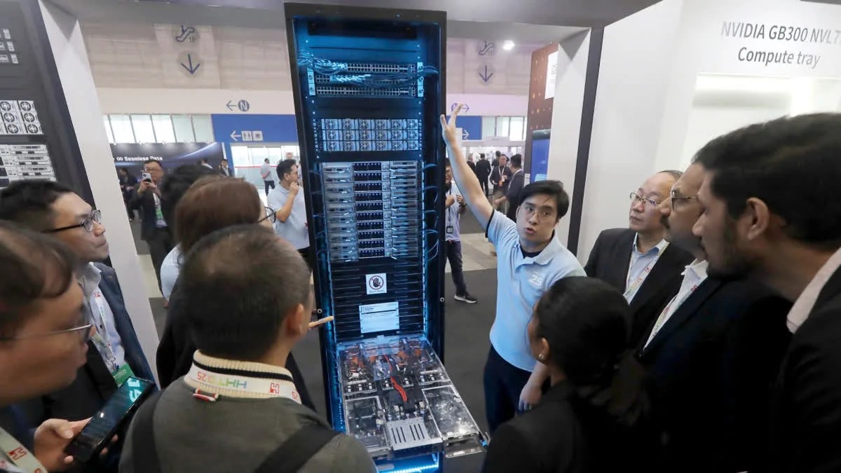 FILE – Visitors listen to the introduction of NVIDIA GB300 NVL72 AI server during the Hon Hai Tech Day (HHTD 25) at the Nangang Exhibition Center in Taipei, Taiwan, Nov. 21, 2025.