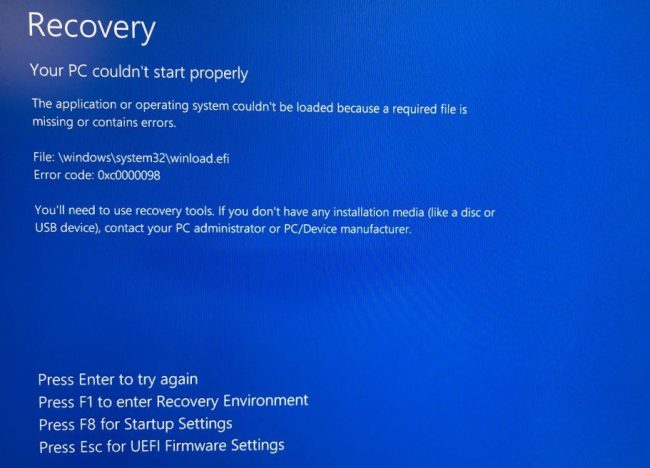 Error message screen indicating PC recovery needed due to a missing or corrupted file, displaying error code 0xc0000098 and instructions for recovery options.