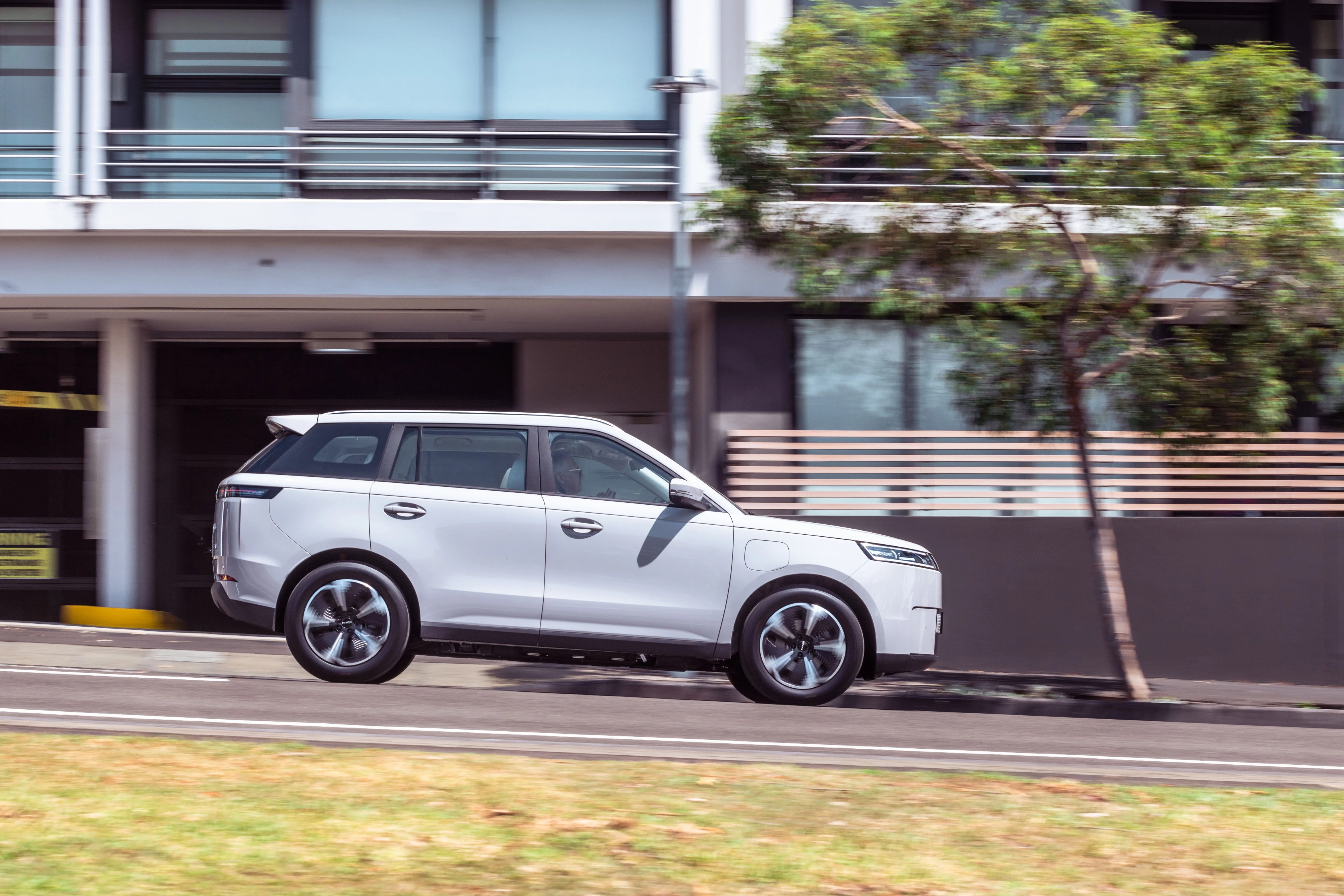 Jaecoo J5 EV driving along a city street