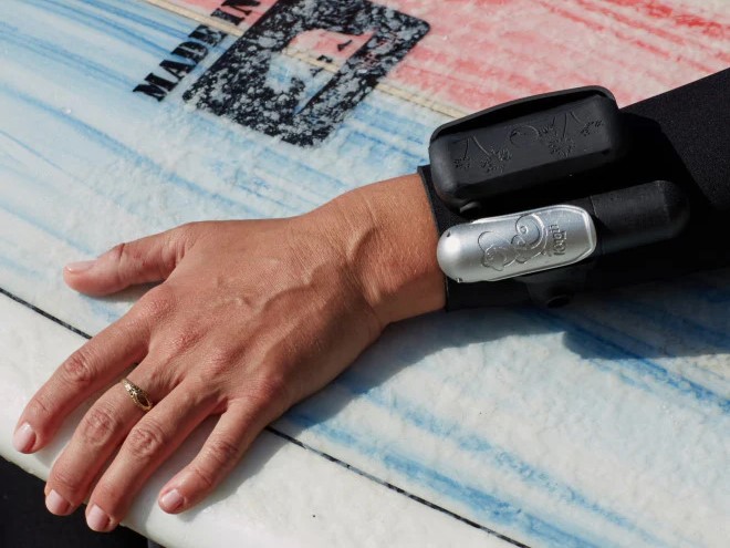 Kingii wrist worn life preserver on user while surfing