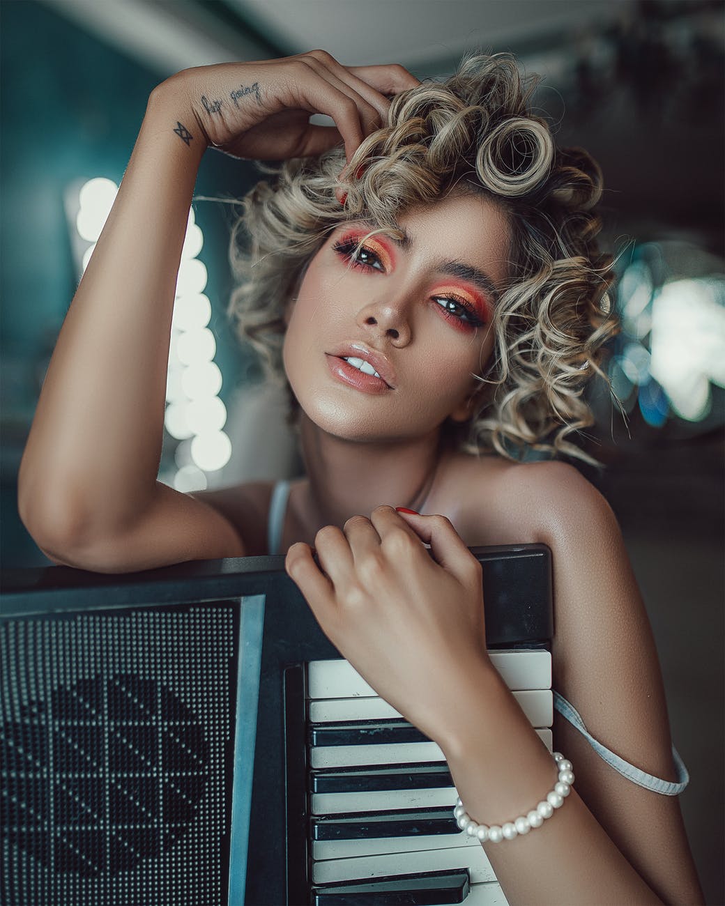 stylish young female artist with synthesizer in dressing room