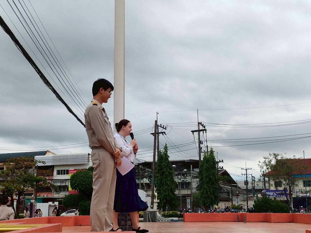 TEFL teacher speaking to students during a school assembly at a secondary school in Thailand while teaching English abroad.