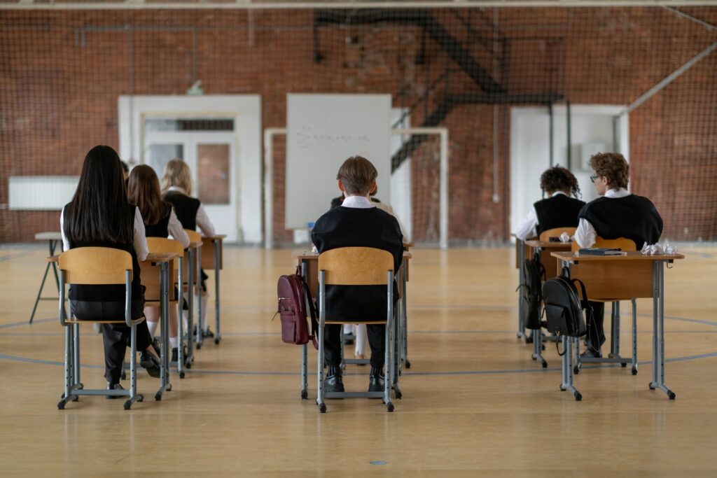 Students seen from behind in a school classroom