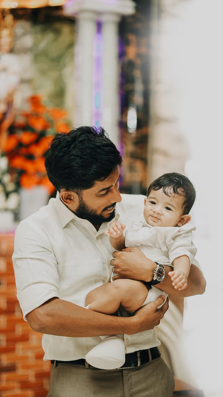 father holding his little son and smiling