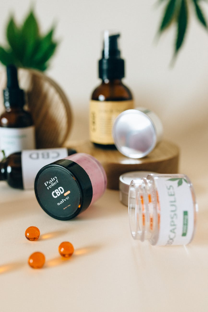 a bottle of cbd product near orange pills