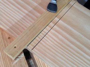 Sawing the edges of the dado.