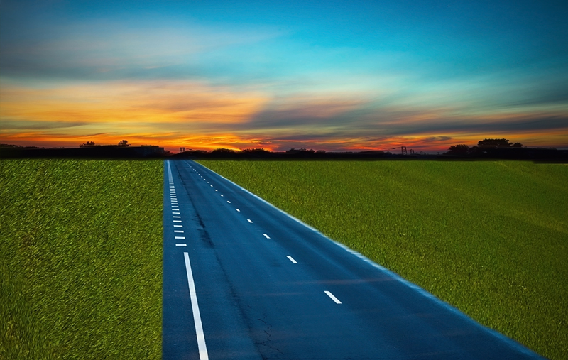 Road in the field at sunset