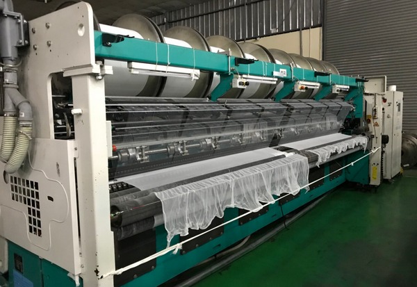 Tricot warp knitting machine