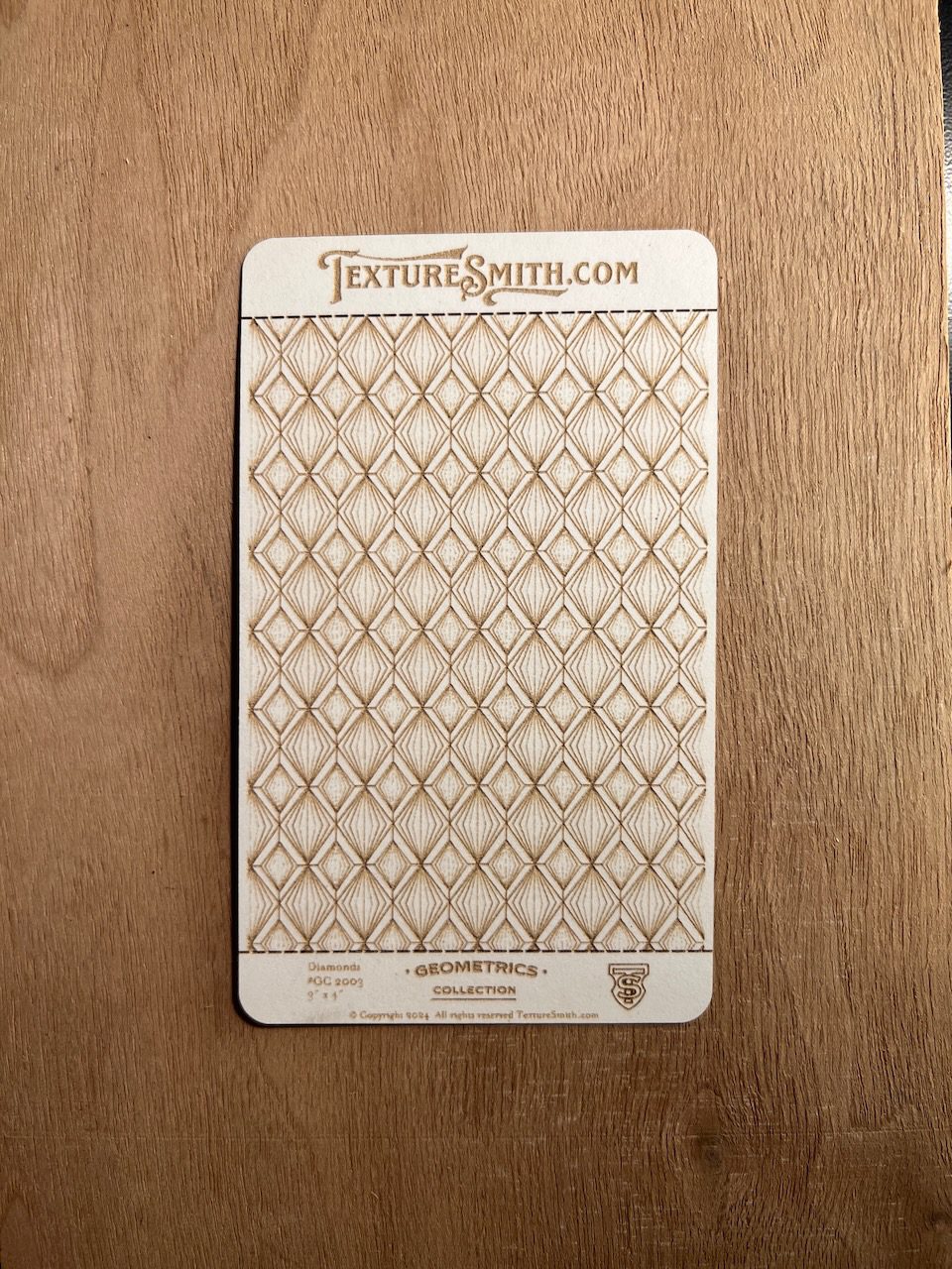 Patterned card with geometric diamond design.