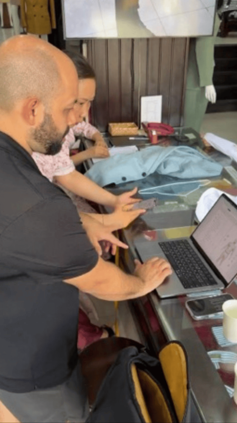 Staff at A Dong Silk reviewing Frank's digital measurements and pattern on a laptop