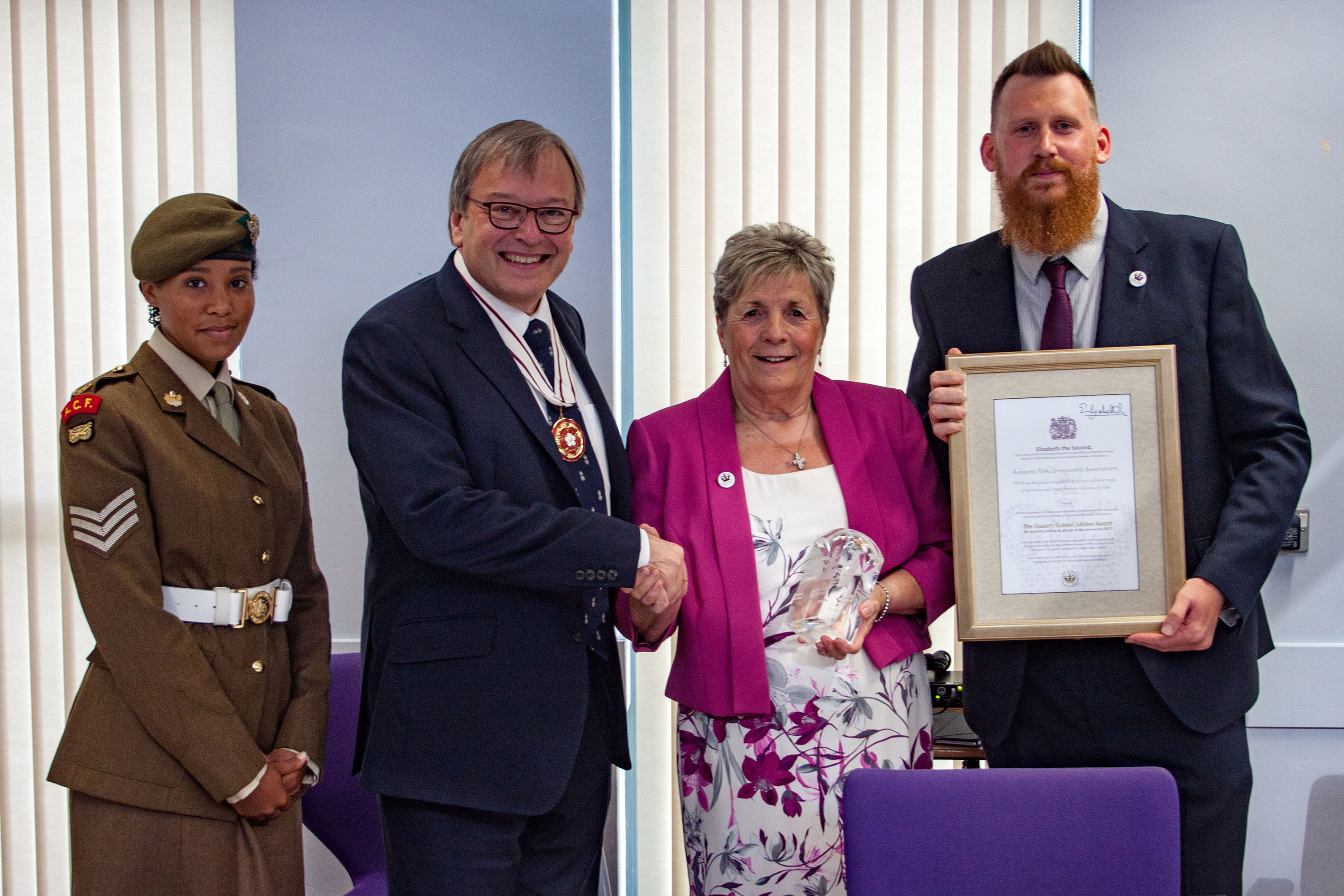 Deputy Lieutenant Simon Topman MBE presents the award