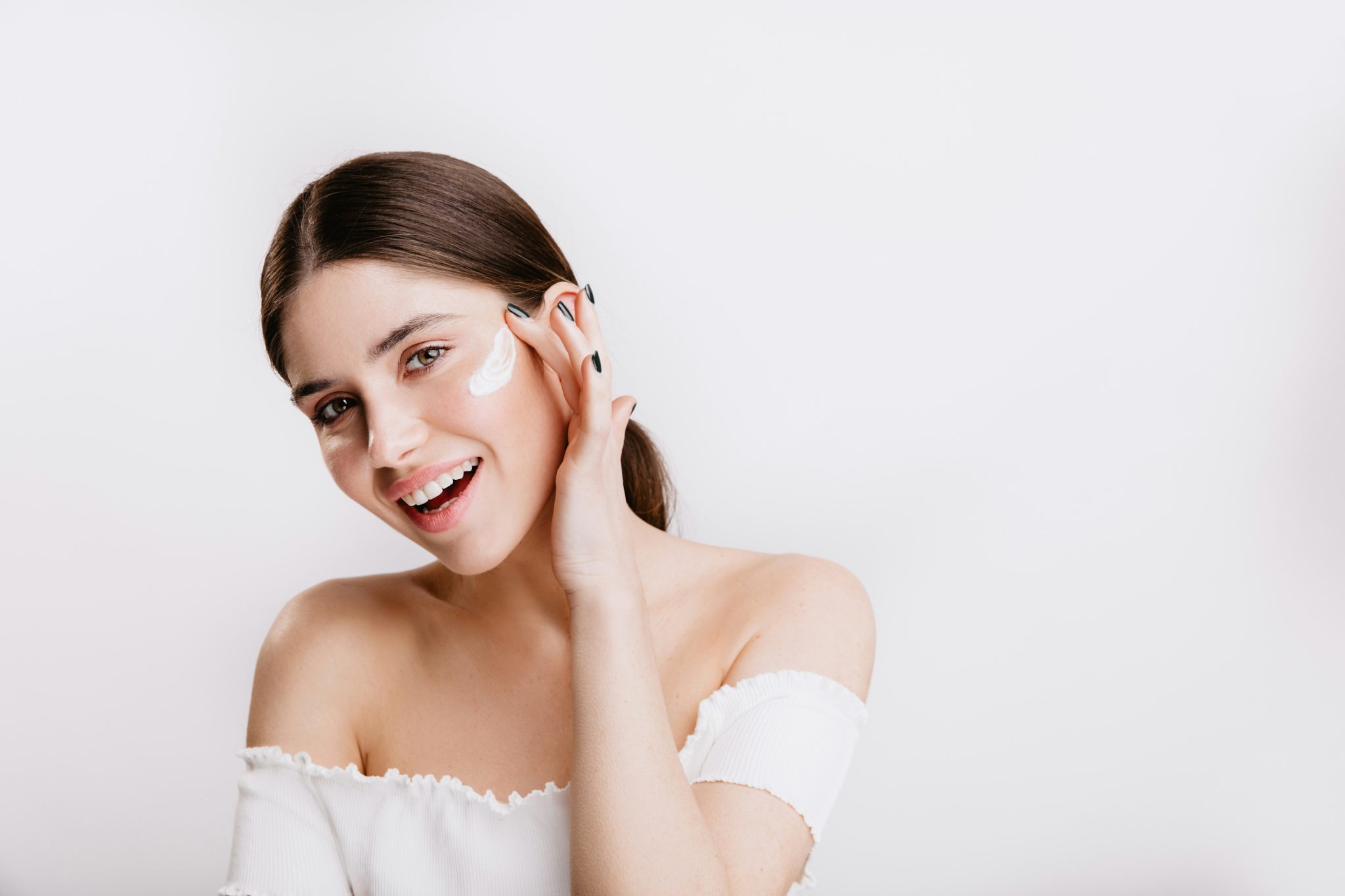 Woman with luminous mature skin touching her face