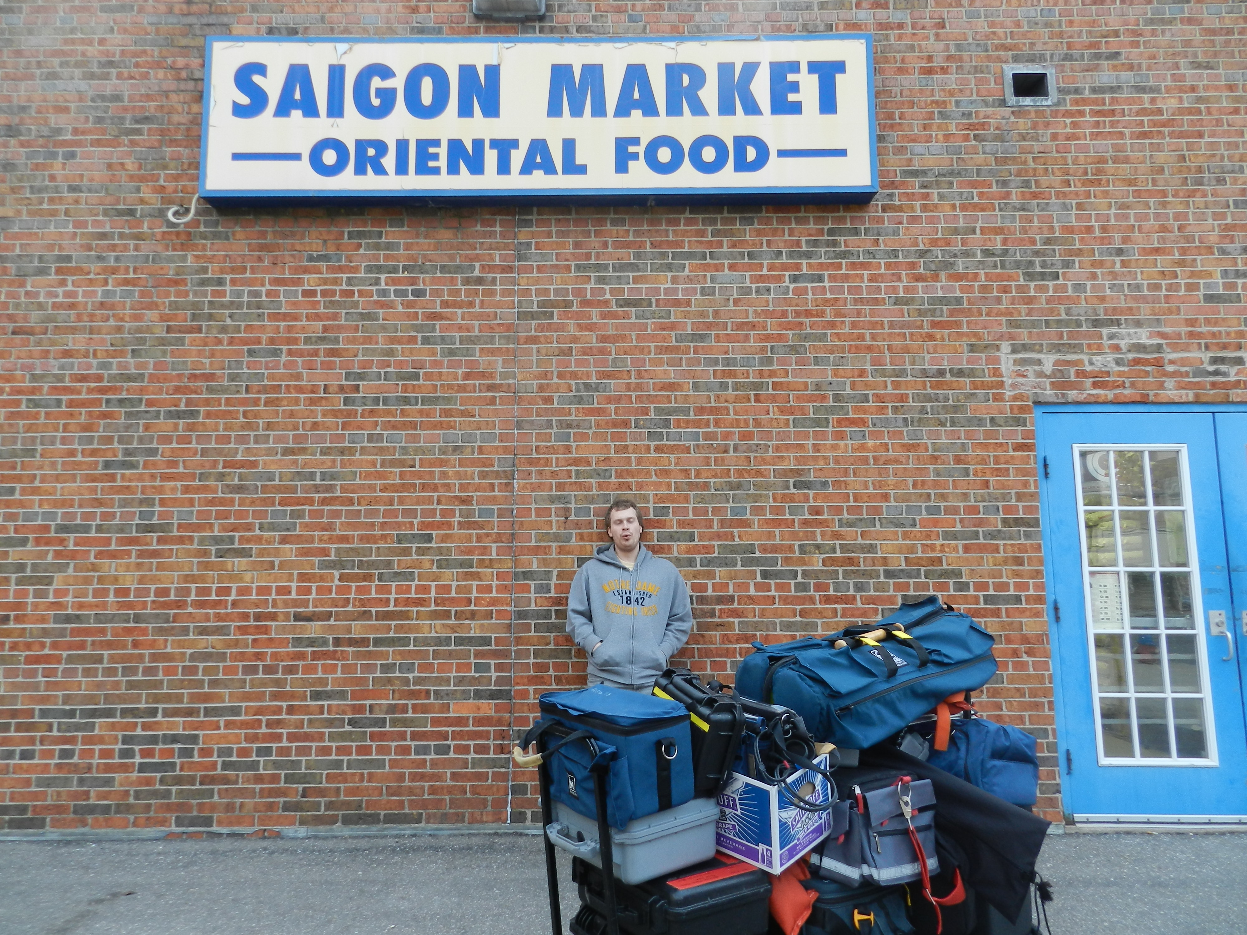 The student co-director waits for his shooting location to close before bringing in the equipment. It turned out that one box, the one with the lens in it, was missing from the pile. The production was held up about 45 minutes as a crew member went back for it.