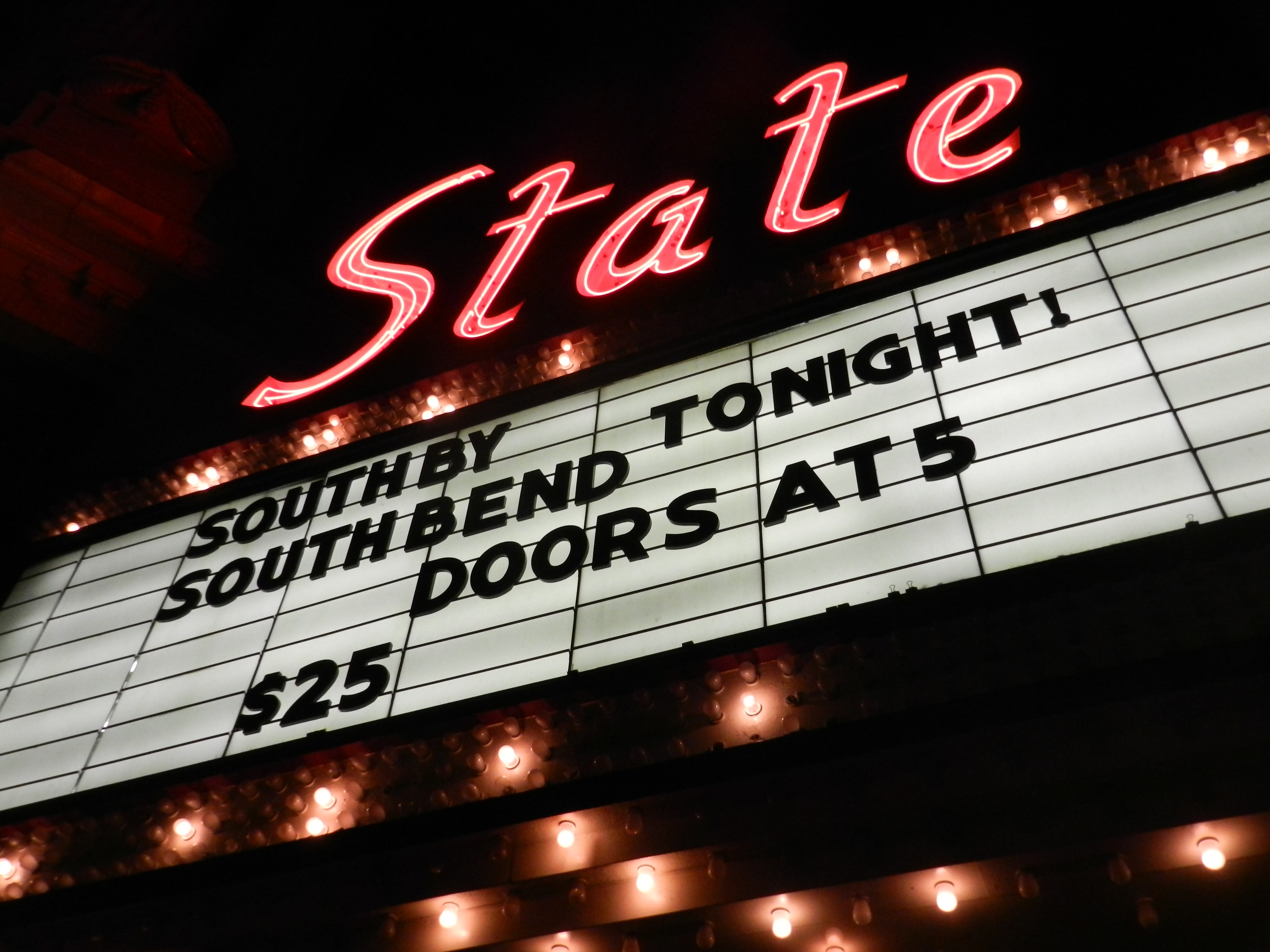 The iconic State Theater marquee was repaired and finally lit up again, proudly advertising a SXSB (South By South Bend) concert. The changing marquee and lights remind downtown South Bend that the theater is back and active after years of disuse.