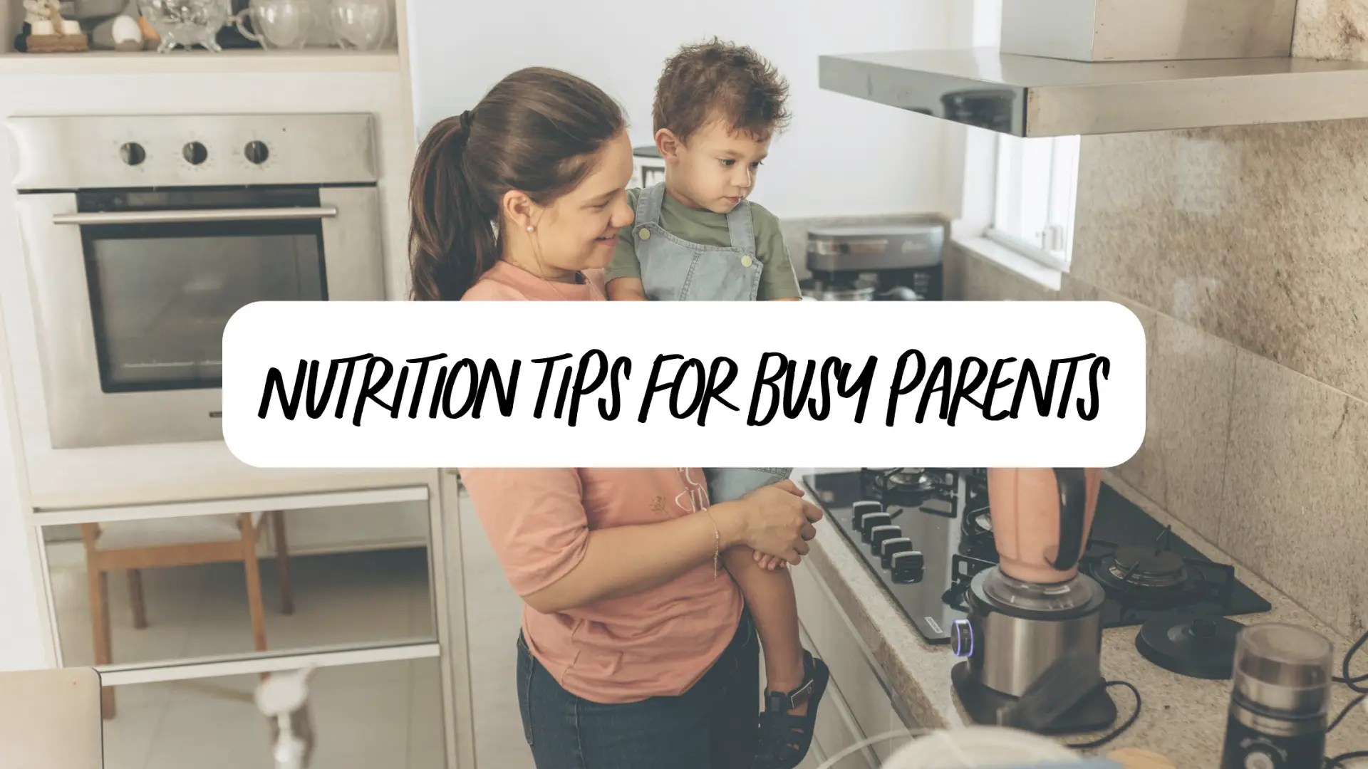 A busy mom makes a nutritious fruit smoothie while holding her toddler son