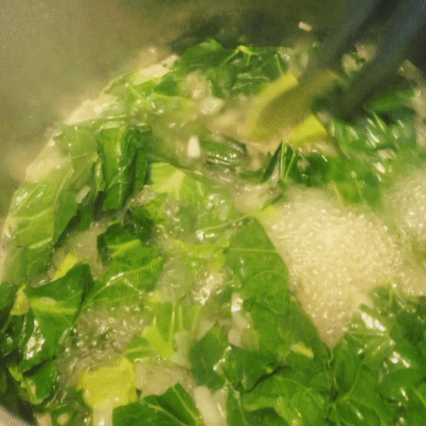 Stirring vegetarian collard greens