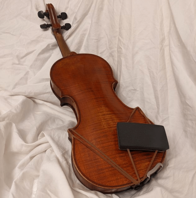 ArcRest Original side-mounted on a full size violin"