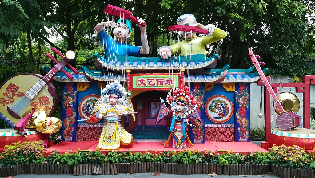 Two puppets operating two other puppets