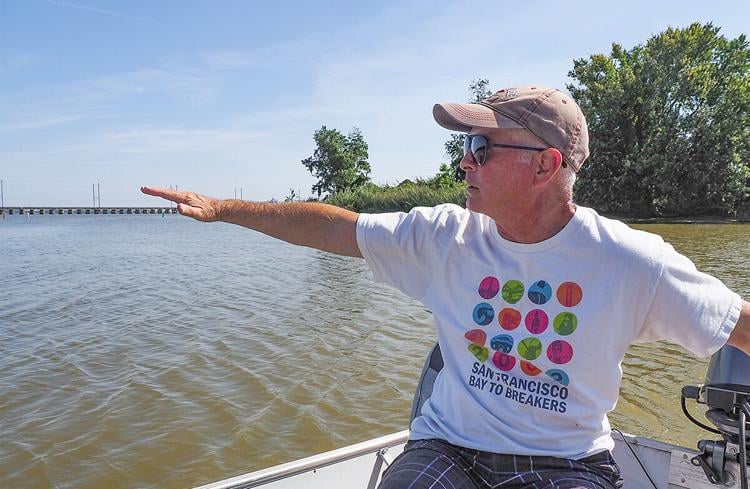 Ralph Comegna, a resident of Joppatowne, MD, points out where submerged grasses once grew in profusion in the lower Gunpowder River.Dave Harp
