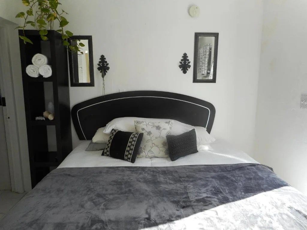 simple guest room with a double bed at blue horizons guest house in warwick, bermuda