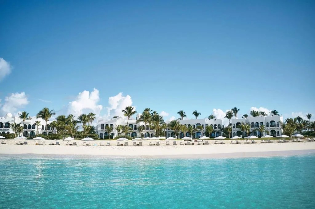 mediterranean styled low white buildings of the cap juluca resort, spanning a beach with perfect white sand and calm blue waters in anguilla