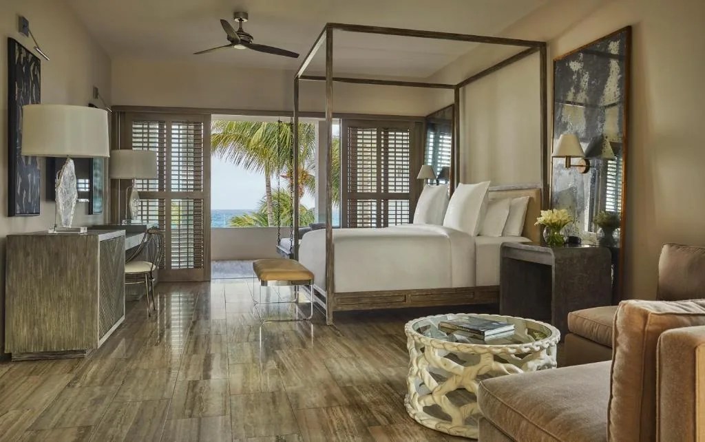 beautiful hotel room at the four seasons in anguilla, with a balcony overlooking the sea