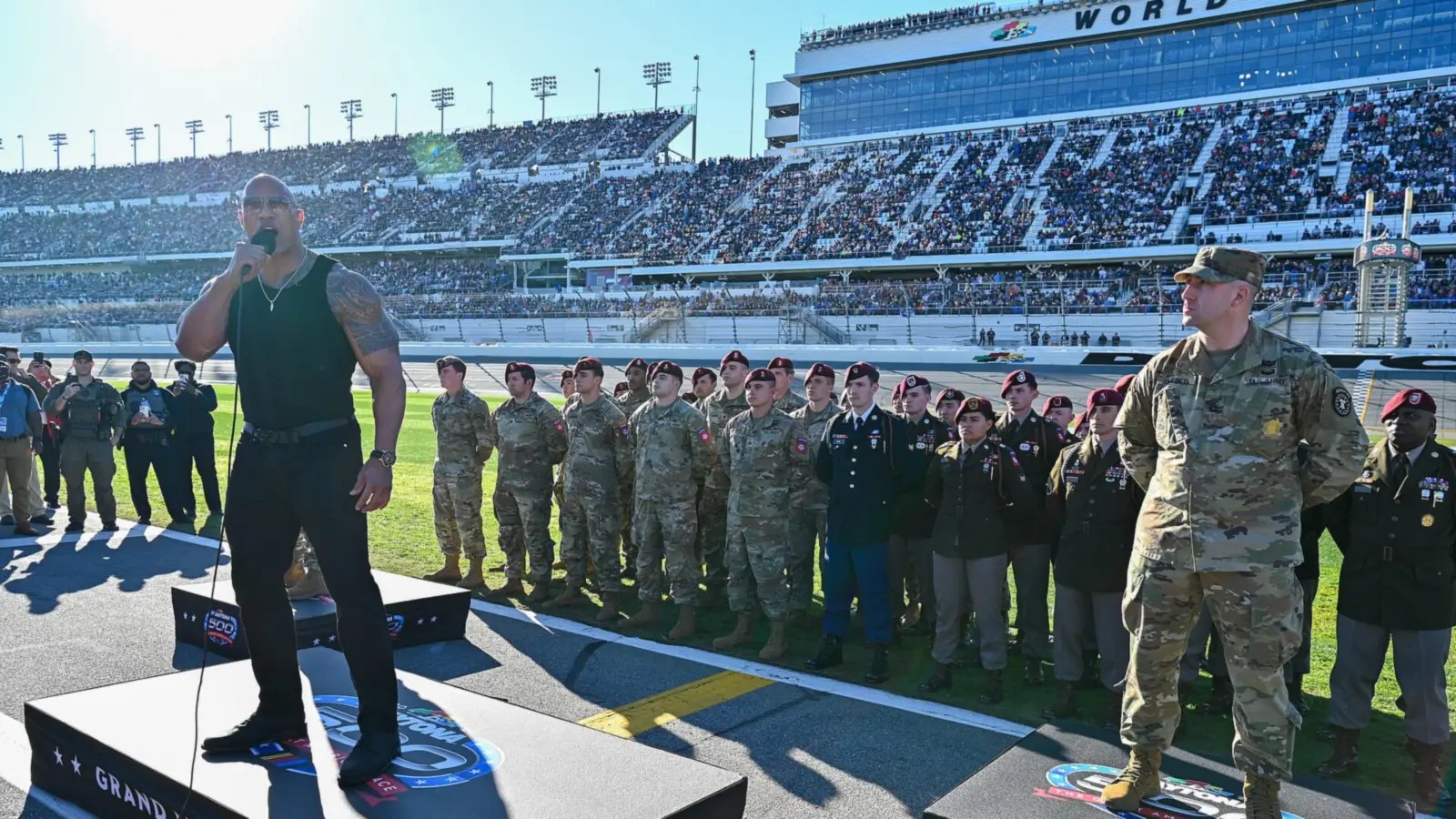 Dwayne Johnson speaking at the 2024 Daytona 500; he stars as the Chicken Man in Lizard Music.