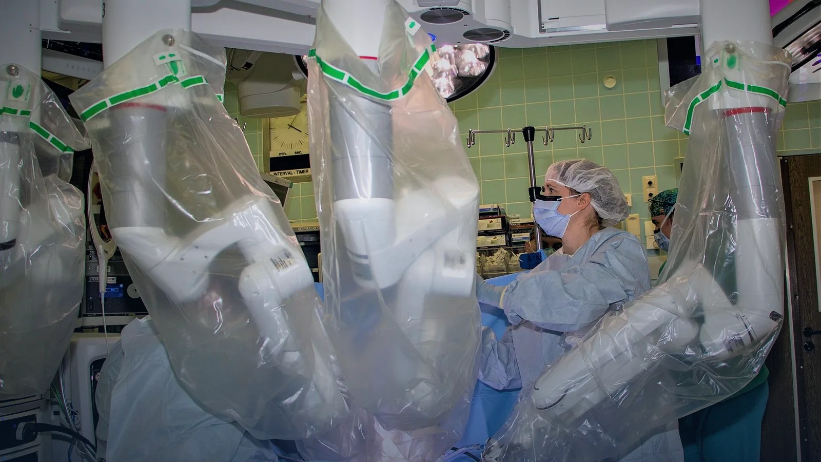 Robotic surgical system arms positioned over a patient in an operating room