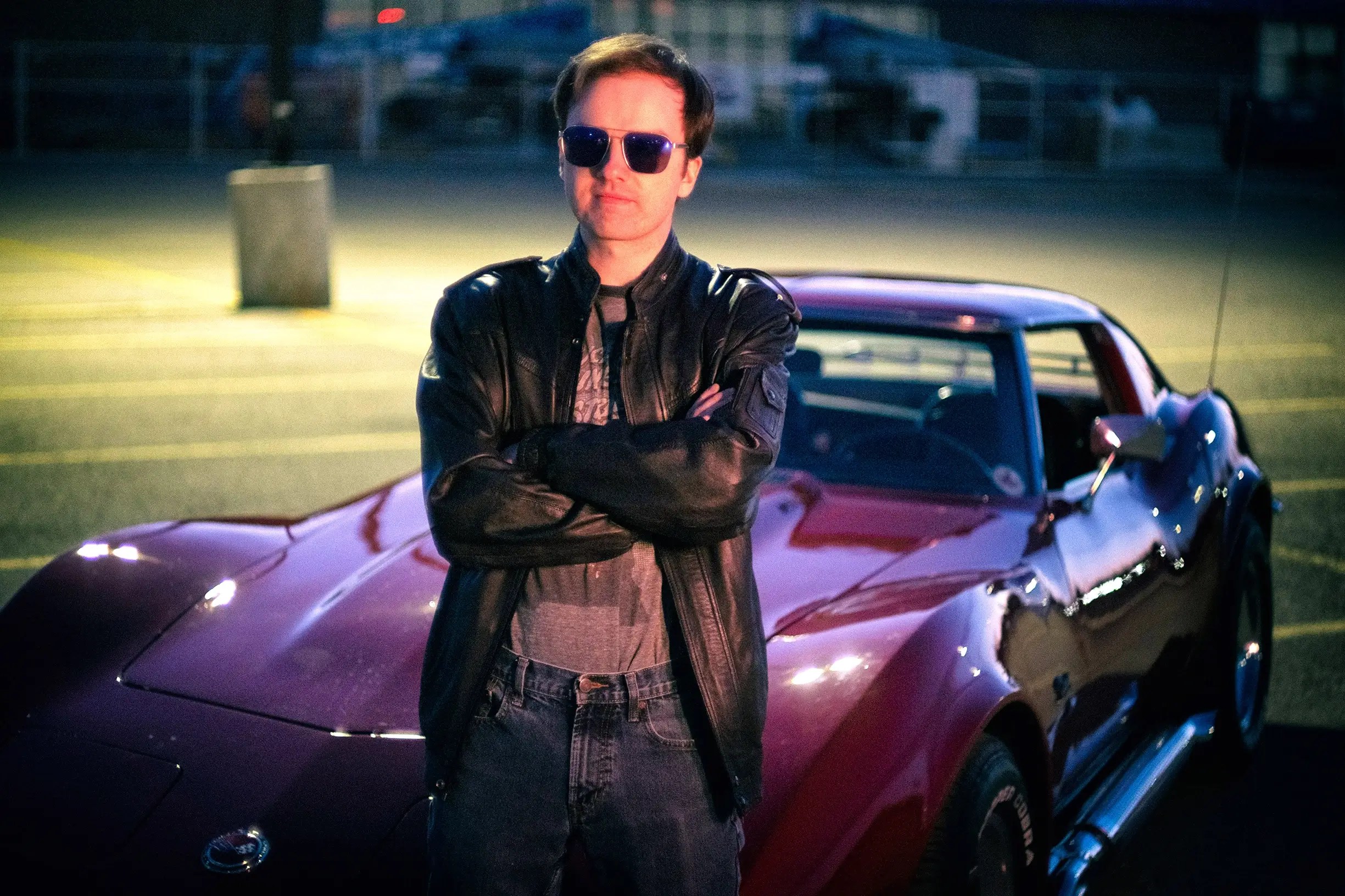 a man standing in front of a car