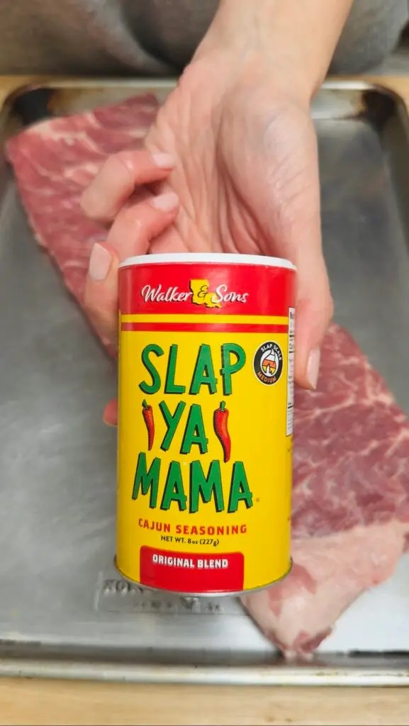 rack of st louis style ribs with slap yo mama seasoning shaker