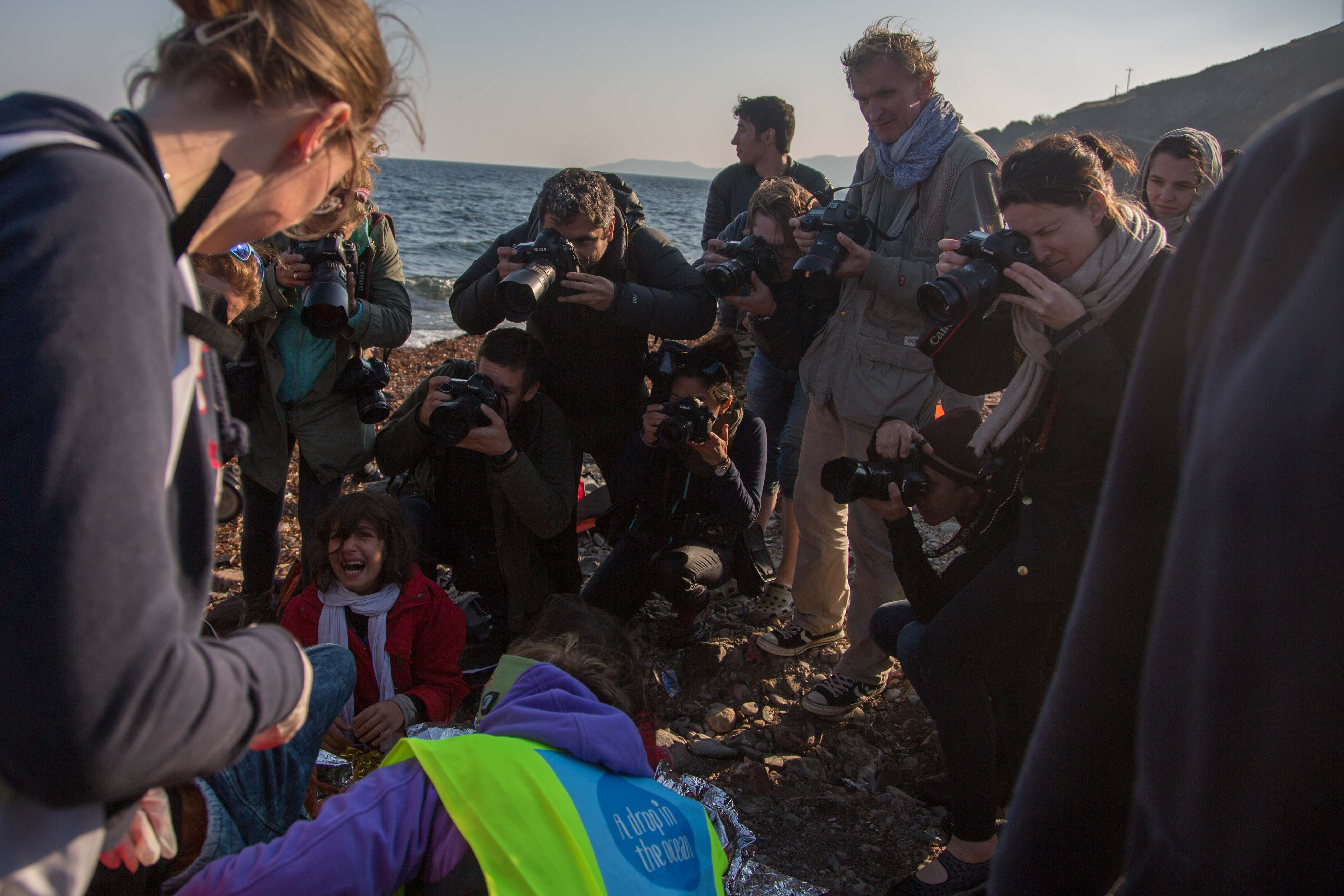 Media madness on the beach, a mix of pro's, amateurs and artists giving the scene a surreal feeling, comfort and suffering such close quarters.