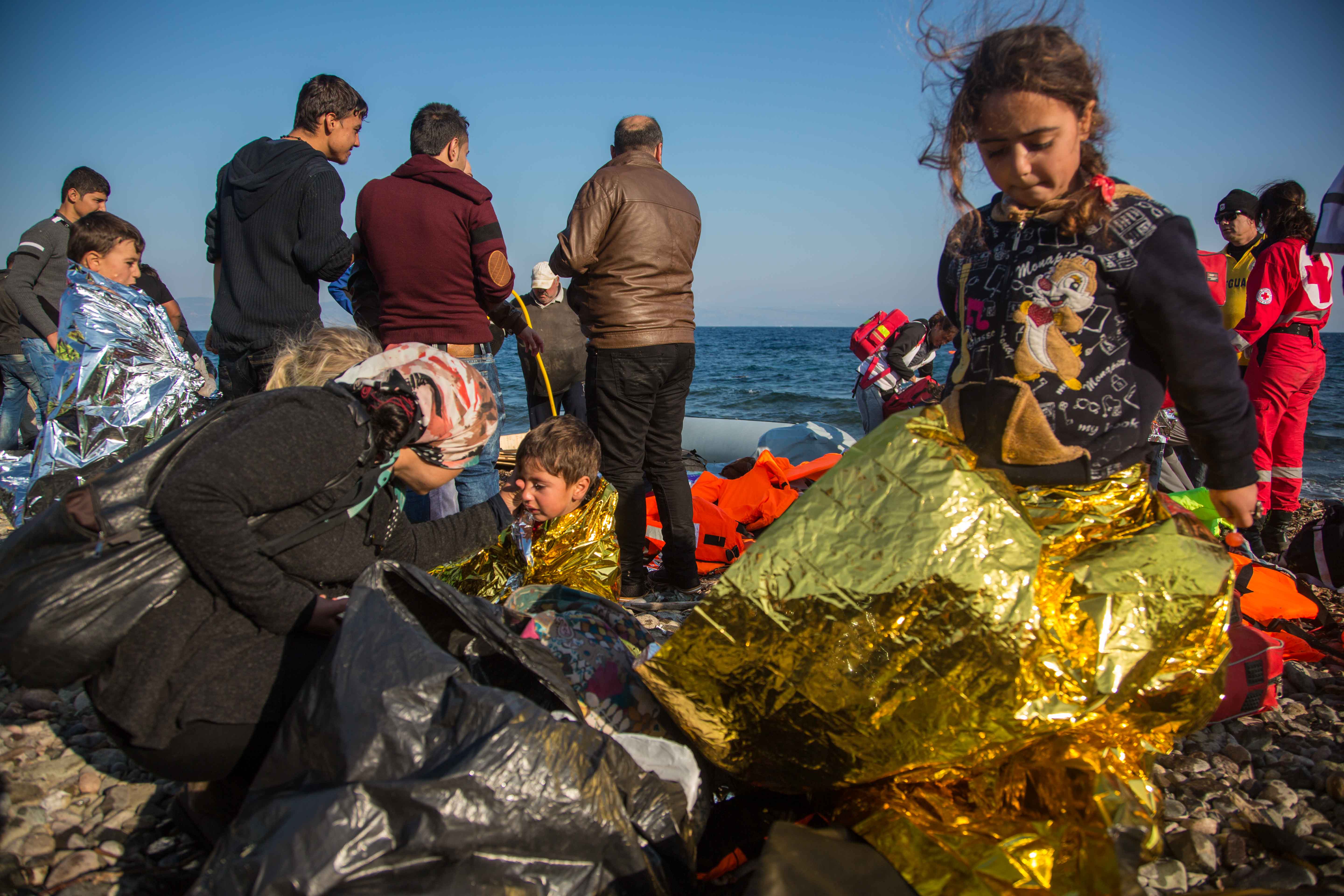 A familiar scene on the beaches of Lesvos, emergency blankets swaddle distressed children as the aid workers mill around.
