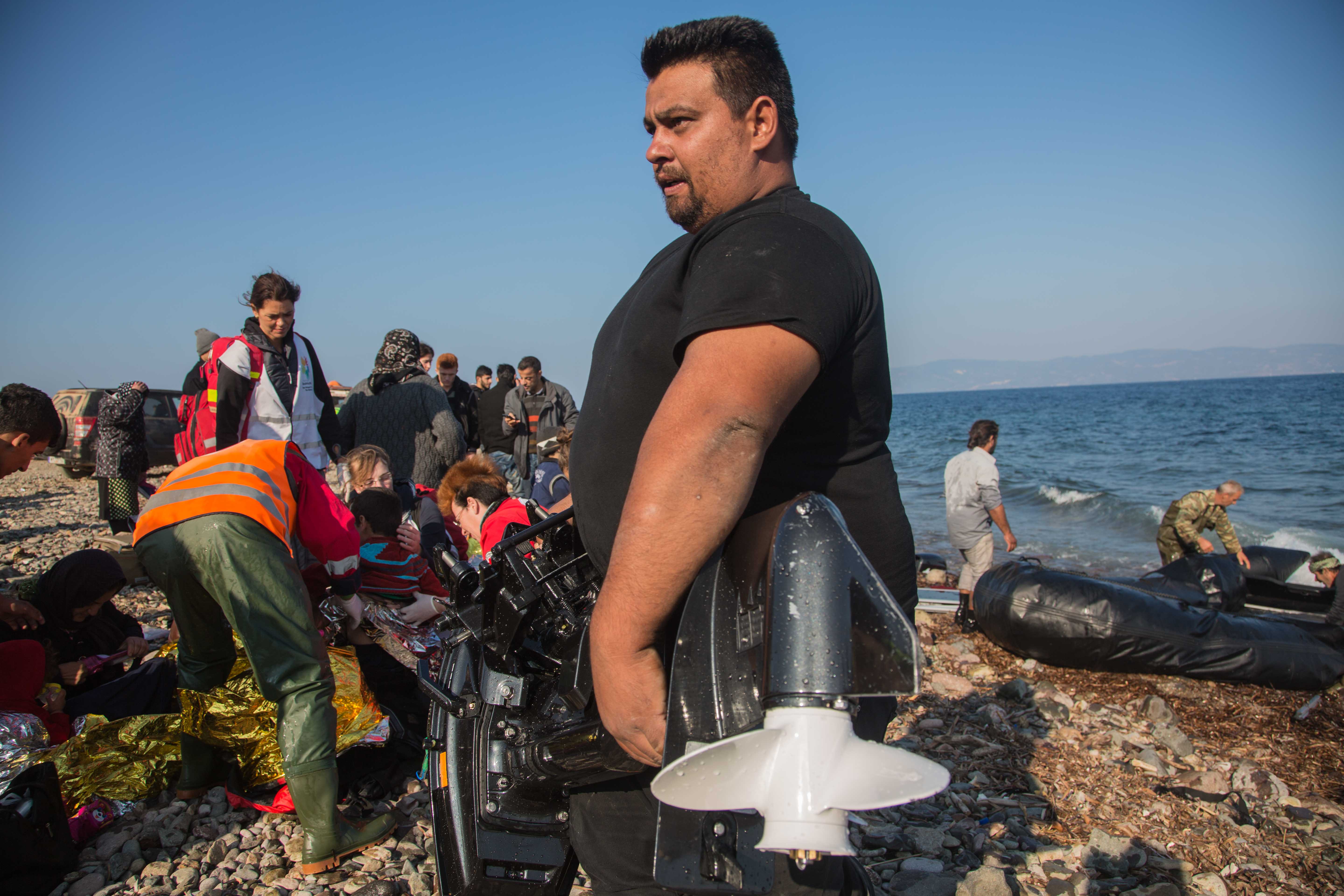 Red cross tend to refugees as the smugglers strip the boat anything valuable. The smuggling route is a established, they have simply switched merchandise.