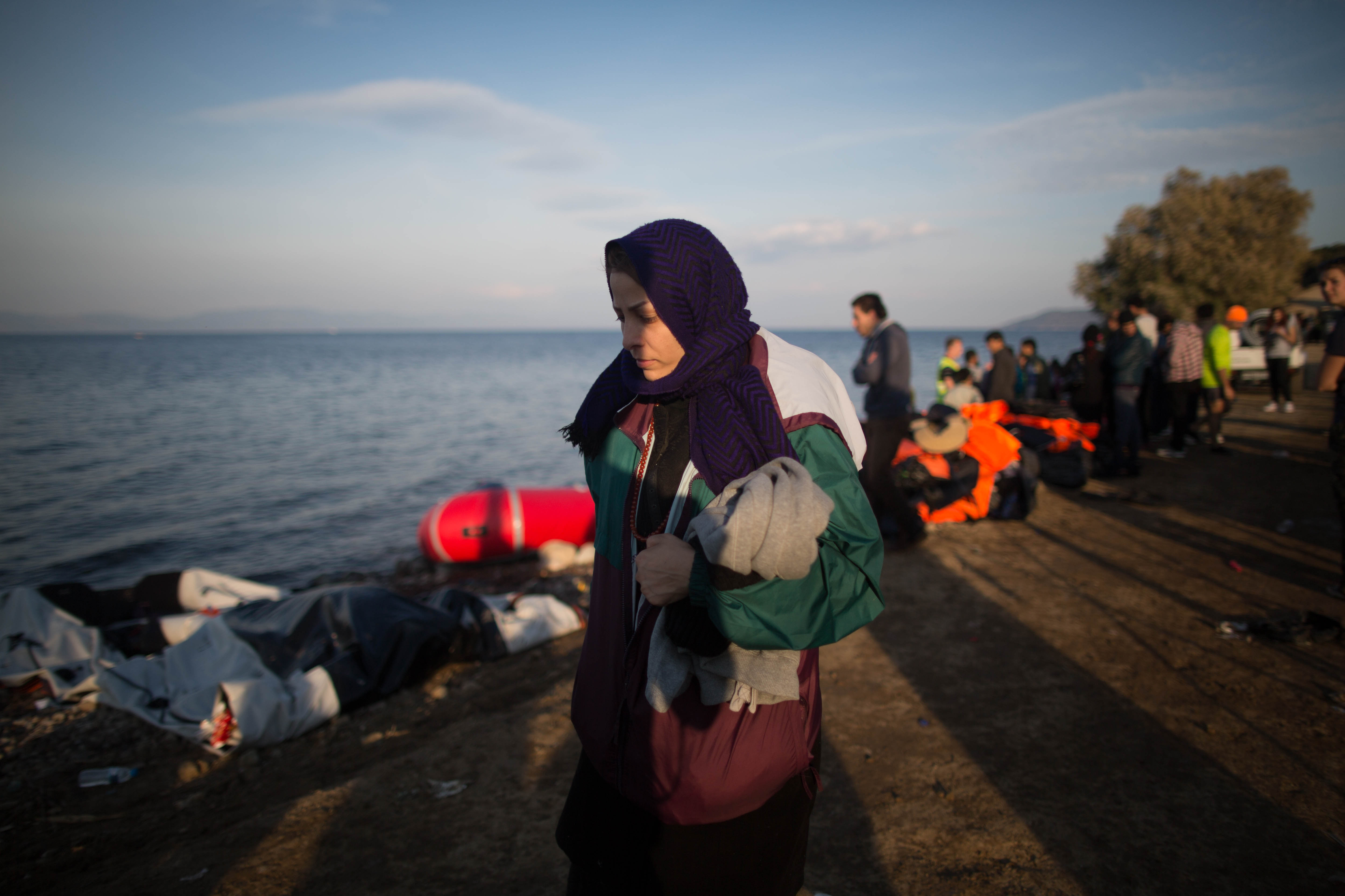 Just off the boat, this woman prepares for the two mile walk to the bus pick up.
