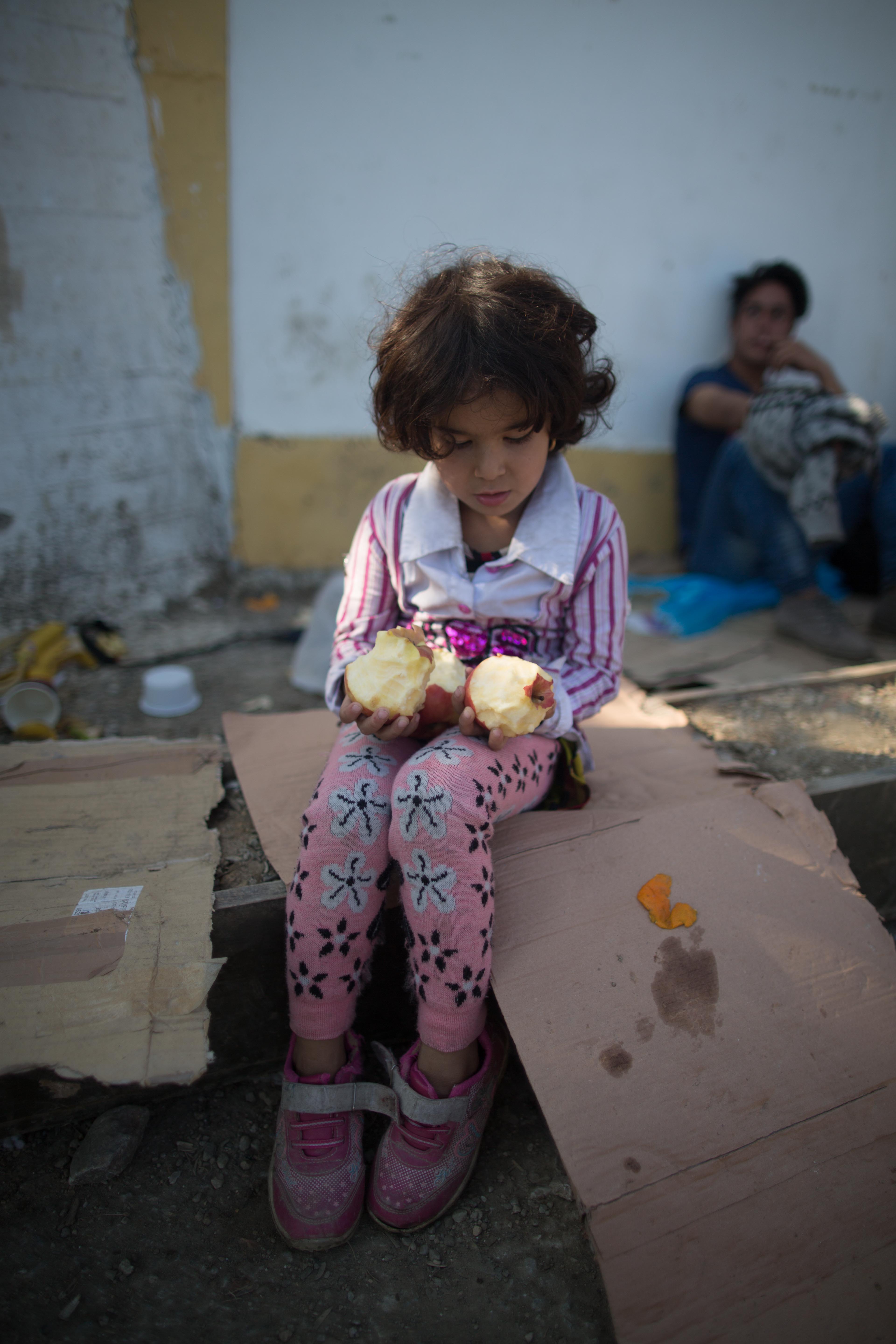 Outside camp Moria. Where to bite when you are 3 apples deep after waiting in line for a half hour to get the fruit? The shock was evident in the faces and actions of the children.