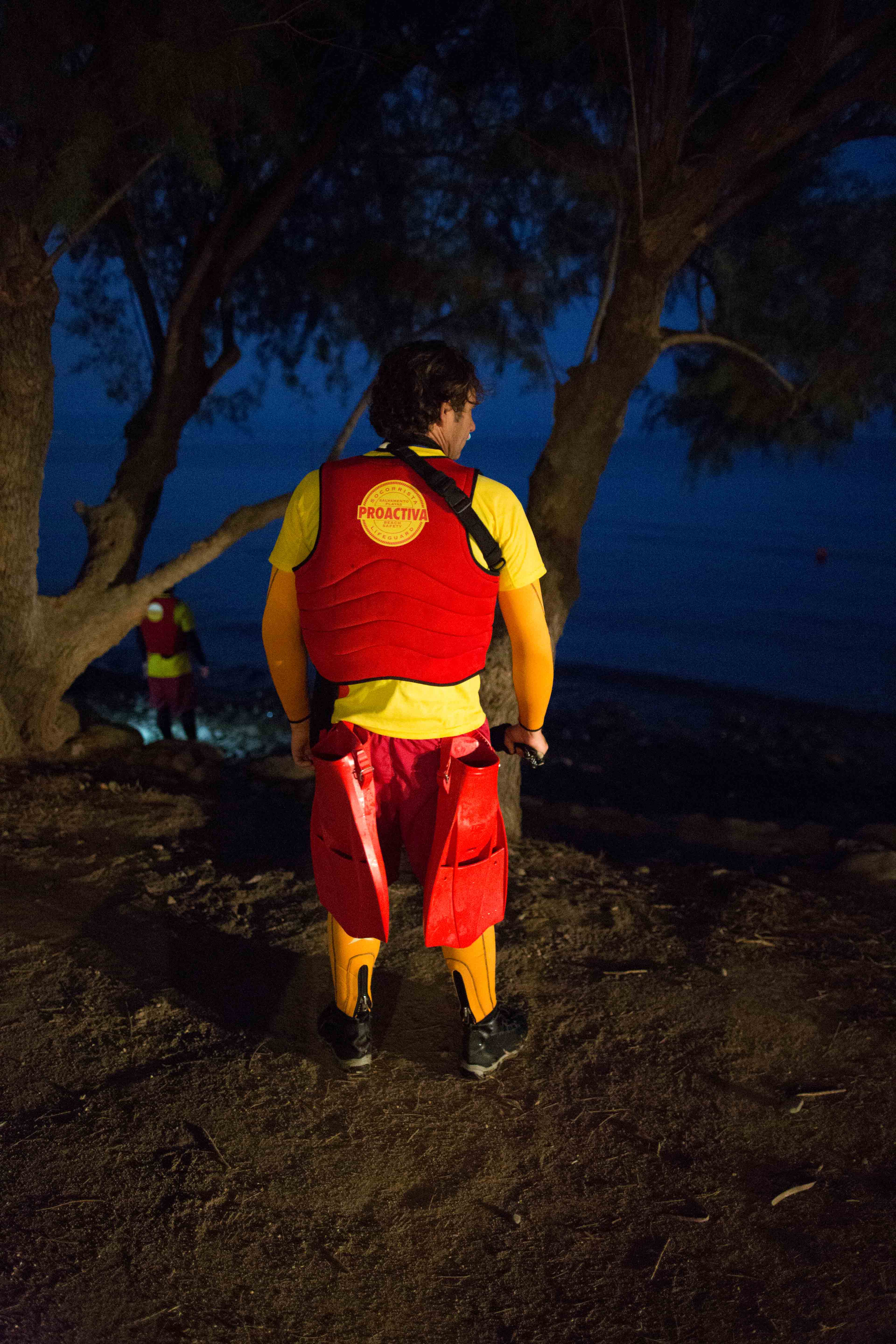Spanish life guards waiting for boats at dusk
