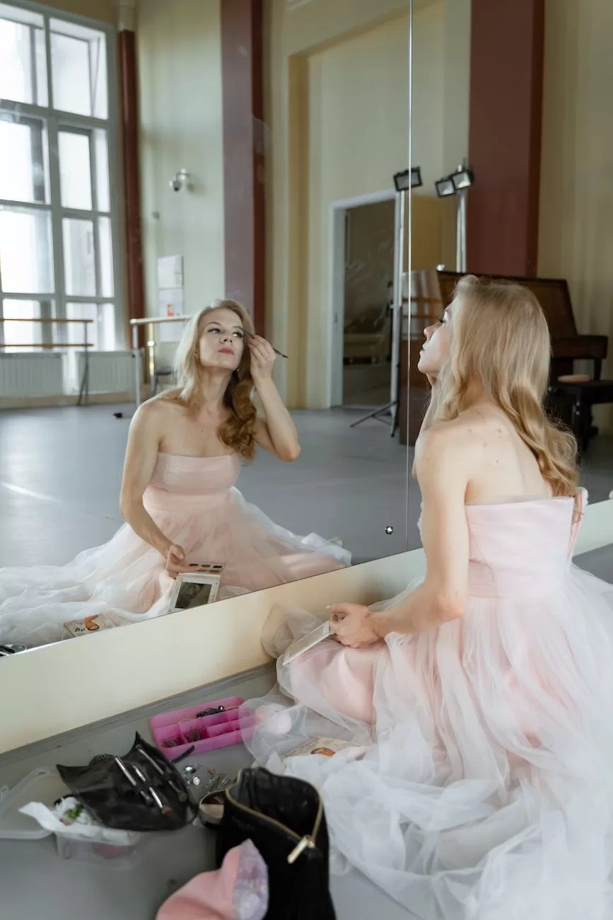 a woman in pink dress sitting on the floor while applying make up on her face