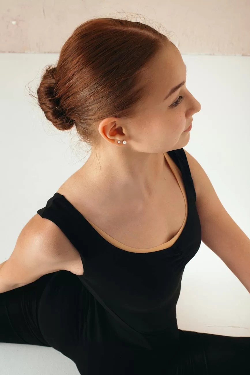 ballerina doing splits while warming up in ballet hall